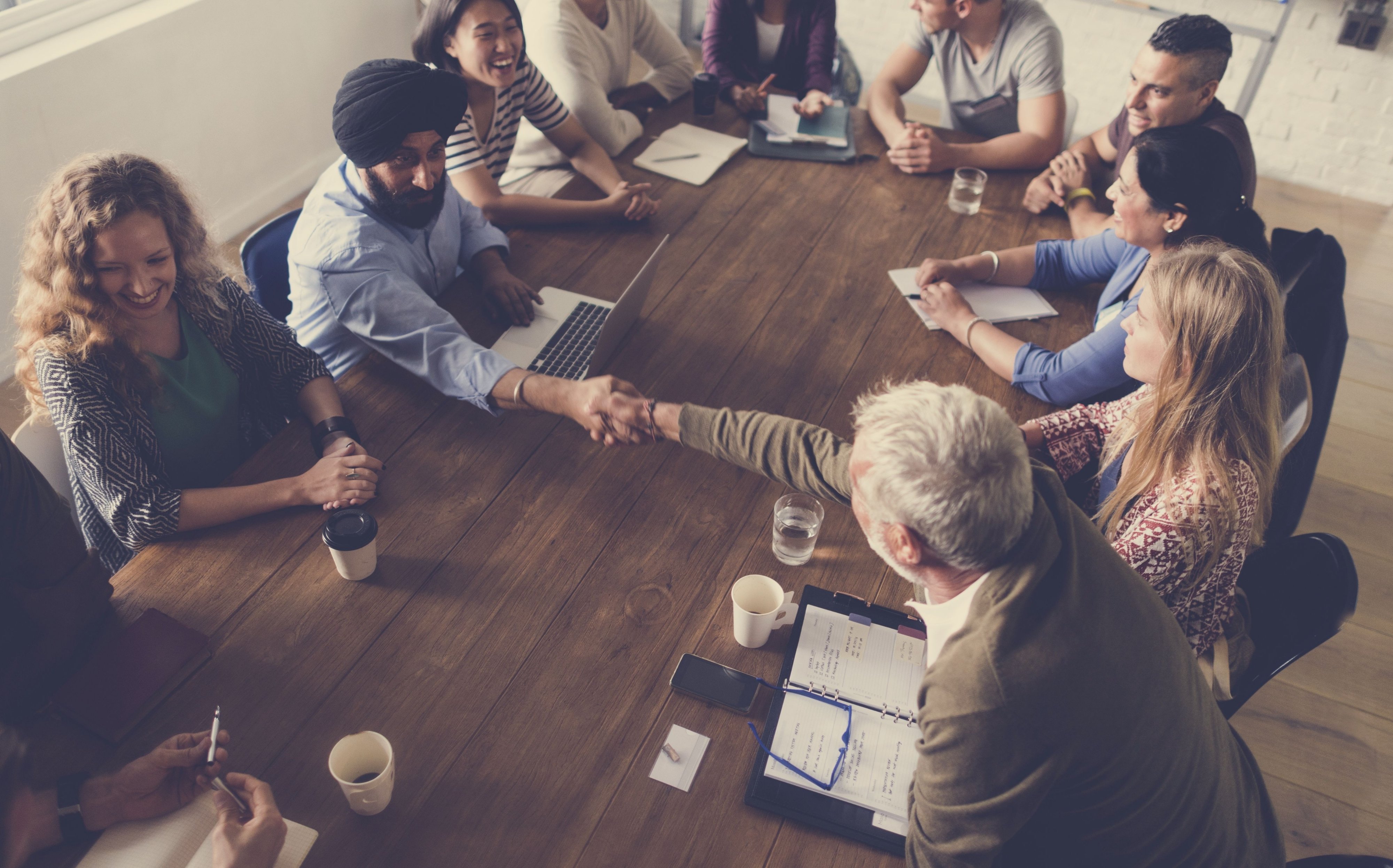 people at meeting shaking hands